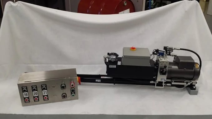 Industrial hydraulic machine with control panel on white backdrop