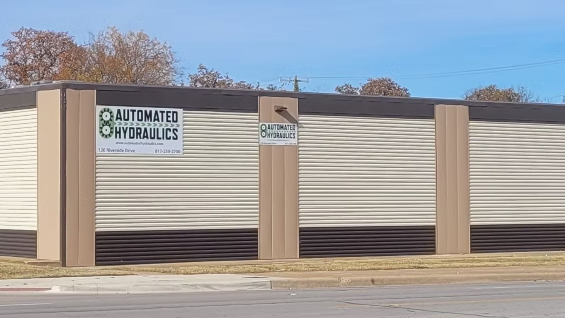 Automated Hydraulics building exterior with logos and corrugated walls
